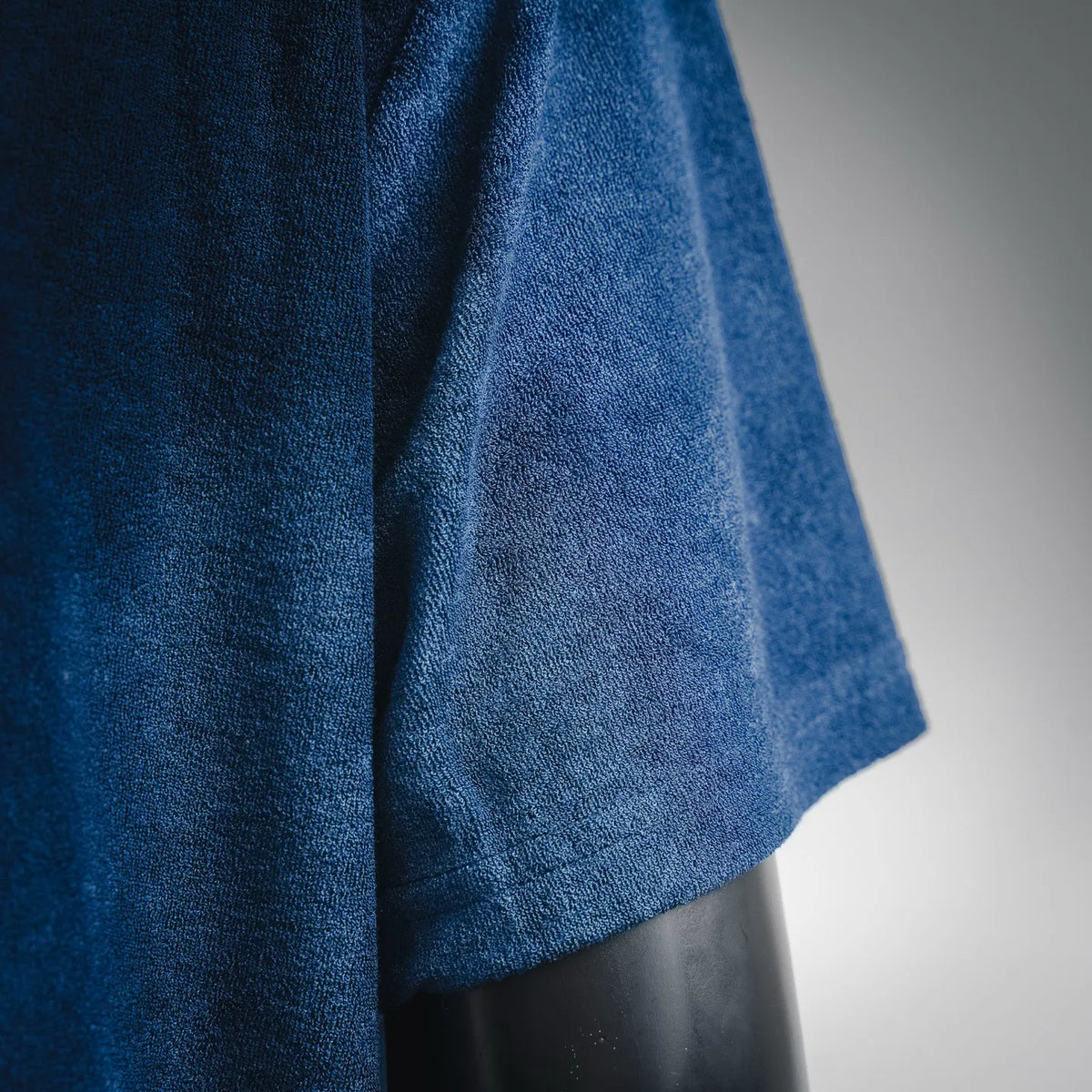 Blue T-shirt side seam and short sleeve cuff detail, textured fabric