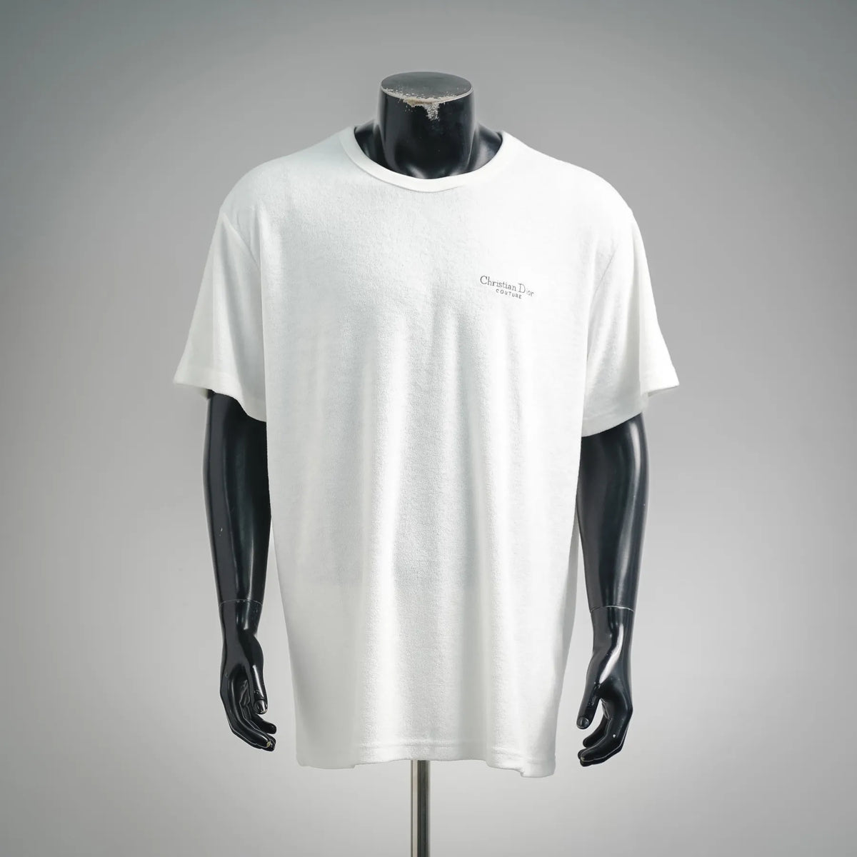 White Christian Dior crewneck short-sleeve T-shirt on a mannequin, small chest logo