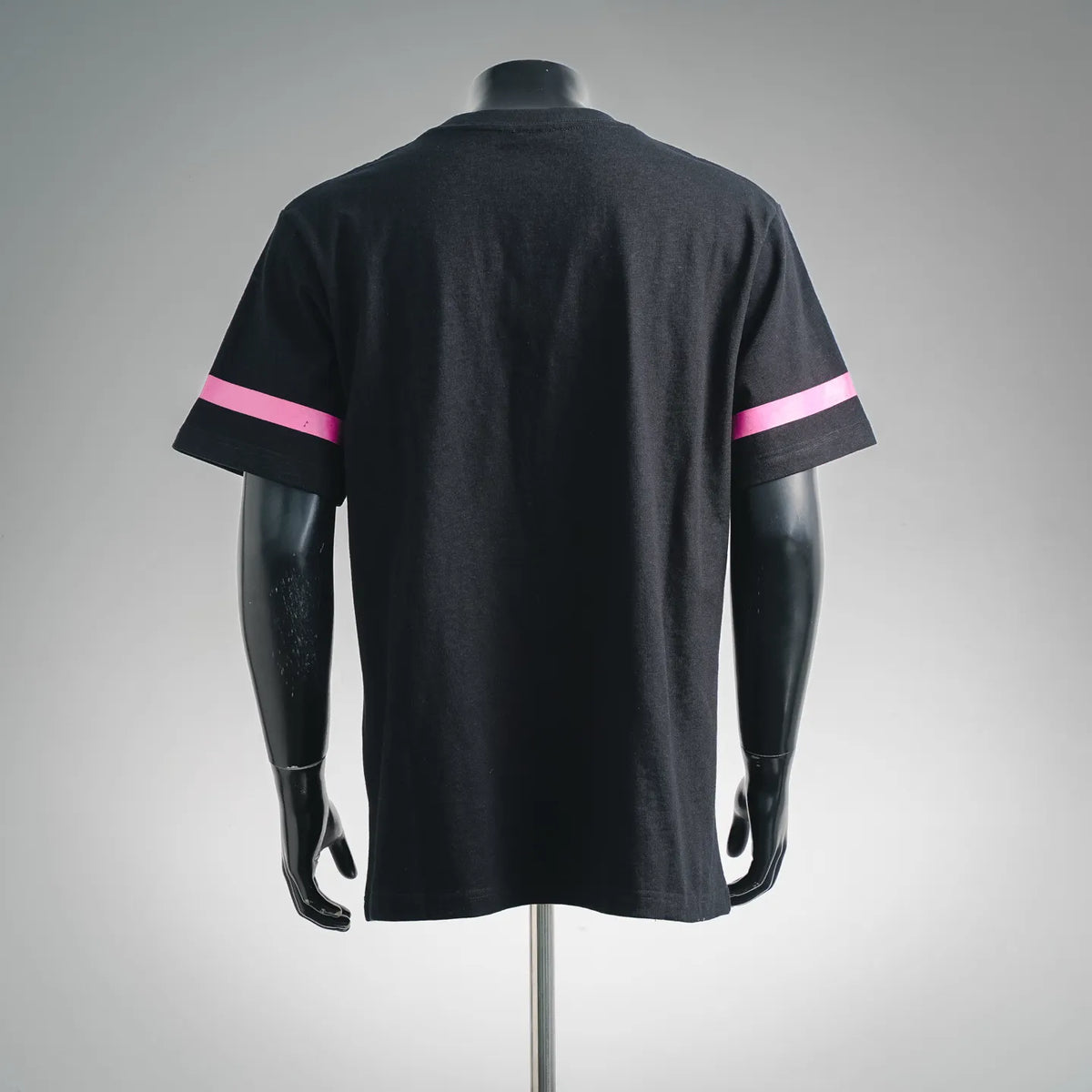 Black crewneck T-shirt on mannequin, back view with pink sleeve stripe