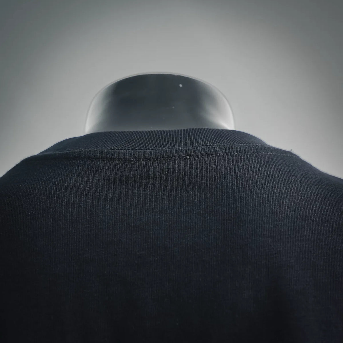 Black crewneck T-shirt collar close-up with ribbed neckline
