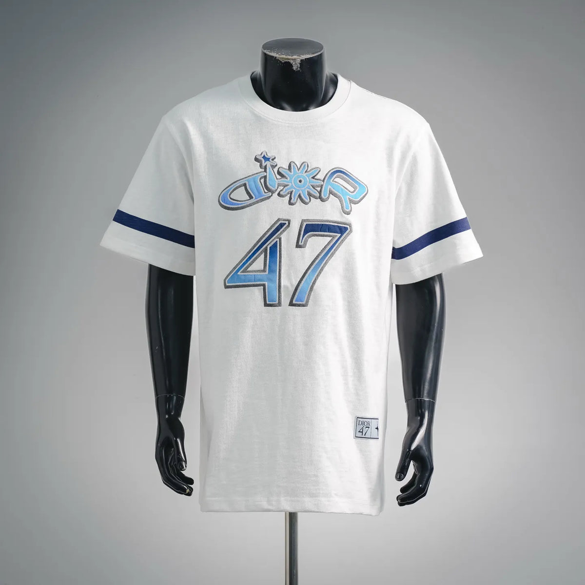 White short-sleeve T-shirt with blue sleeve stripes and '47' front graphic.