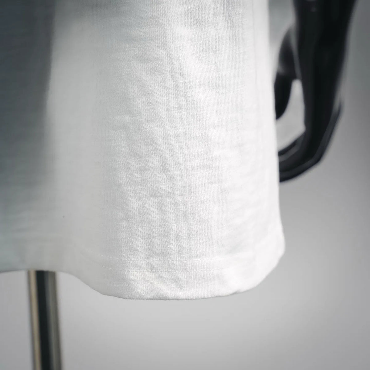 White crew neckline and smooth knit fabric on a short-sleeve T-shirt.