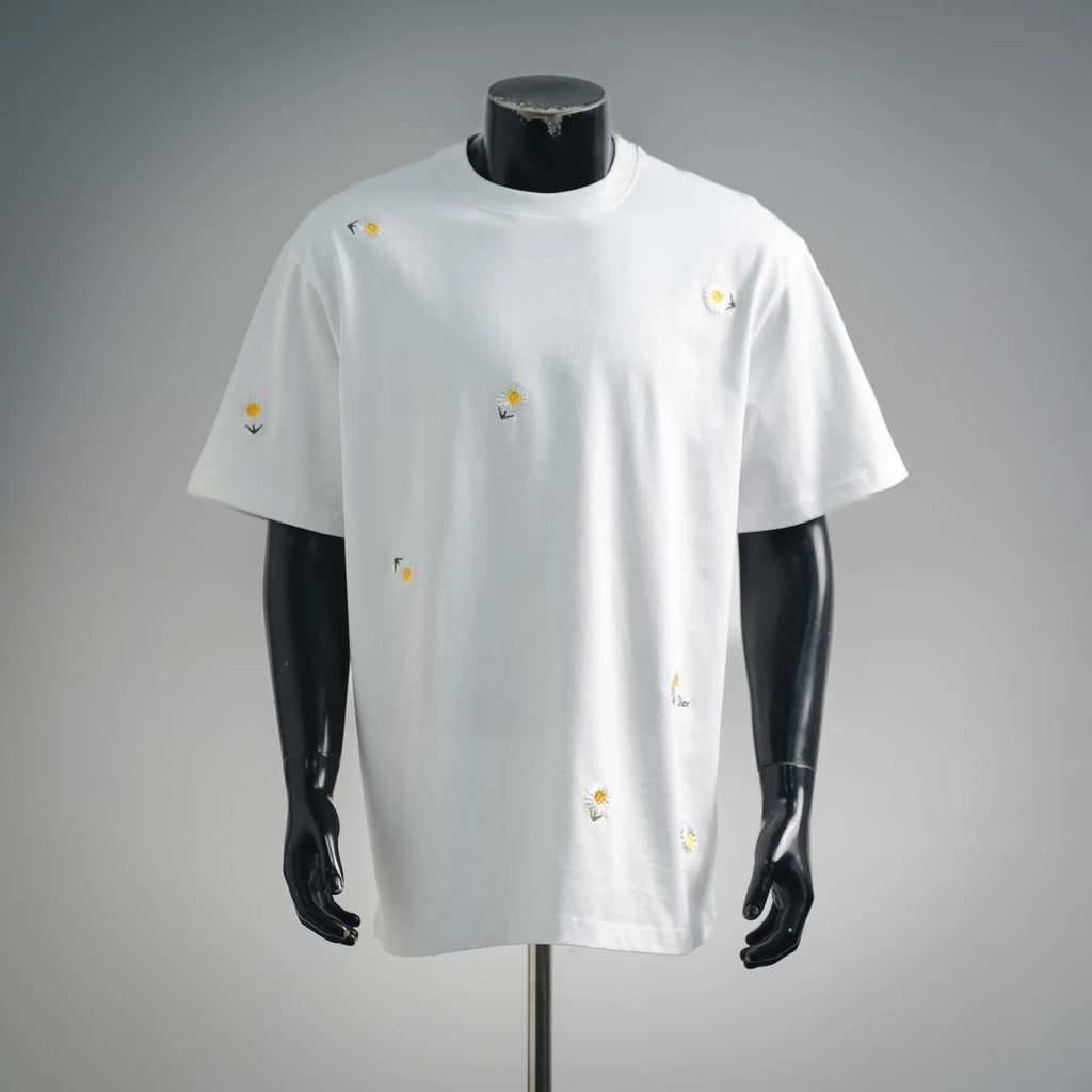 White short-sleeve T-shirt with small yellow daisy embroidery, crew neck