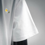 White T-shirt with embroidered daisy on left chest, short sleeves