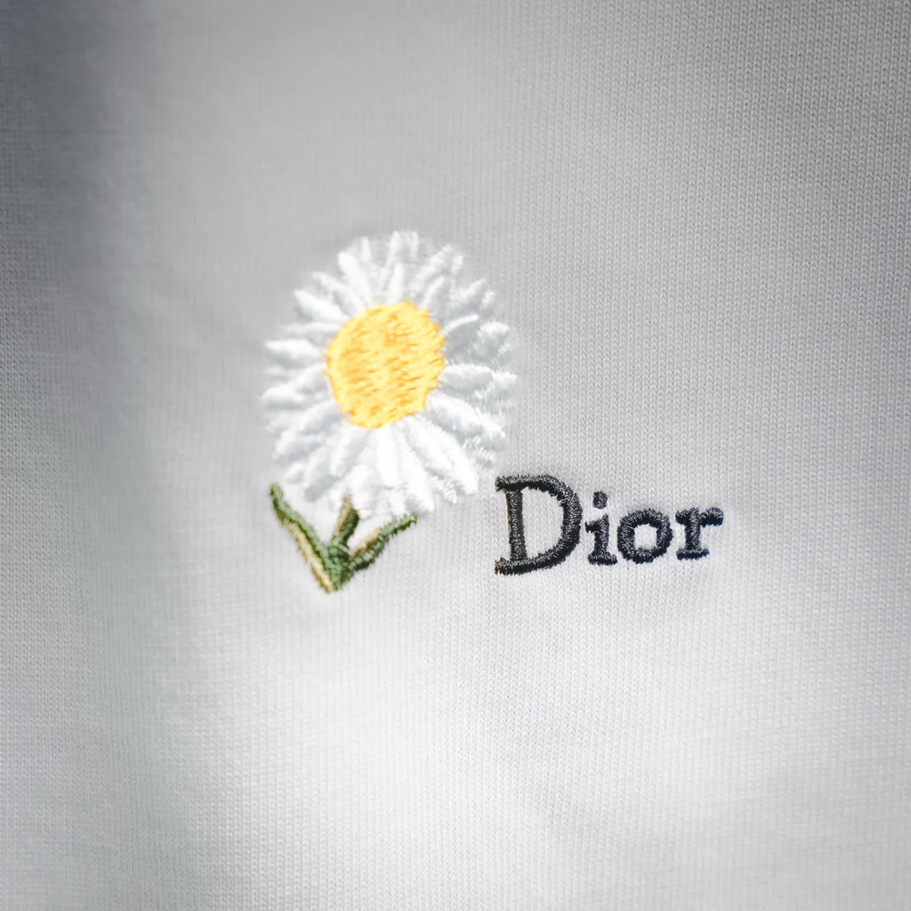 Daisy and Dior embroidery on white T-shirt fabric