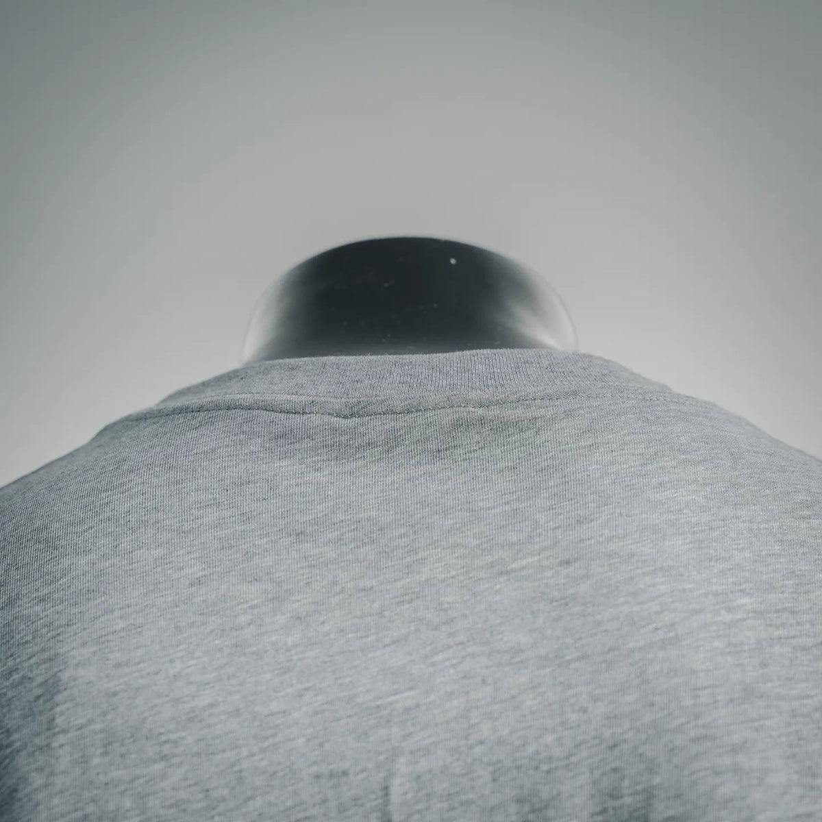 Heather gray T-shirt neckline and shoulder seam, rear view