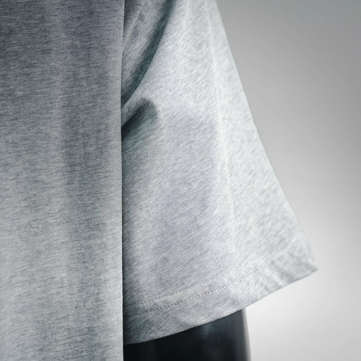Heather gray T-shirt sleeve and side seam detail