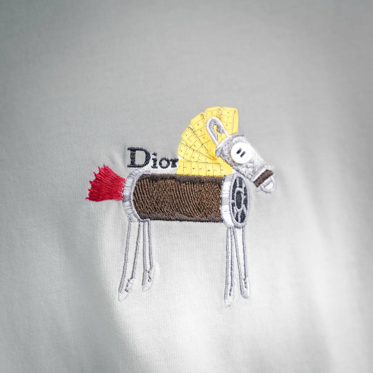White T-shirt with embroidered Dior logo and small multicolor motif on chest