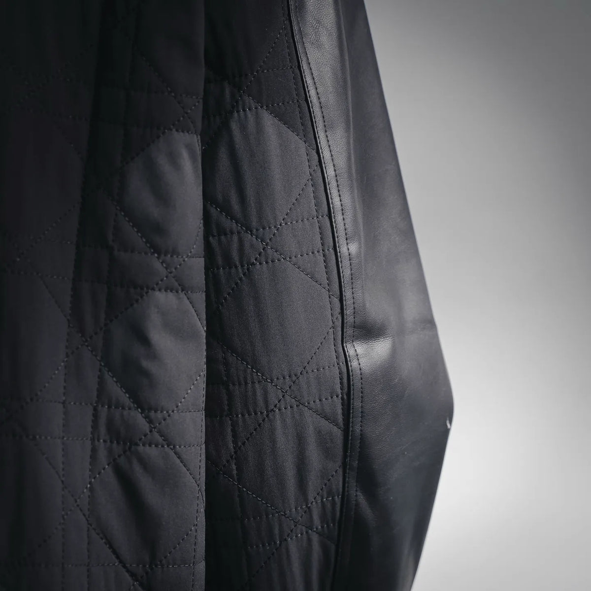 Christian Dior black leather jacket panel close-up with diamond-quilted texture