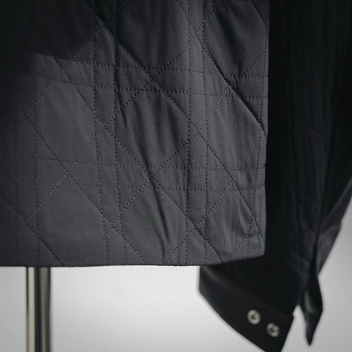 Christian Dior black leather jacket lower front close-up with quilted diamond panels