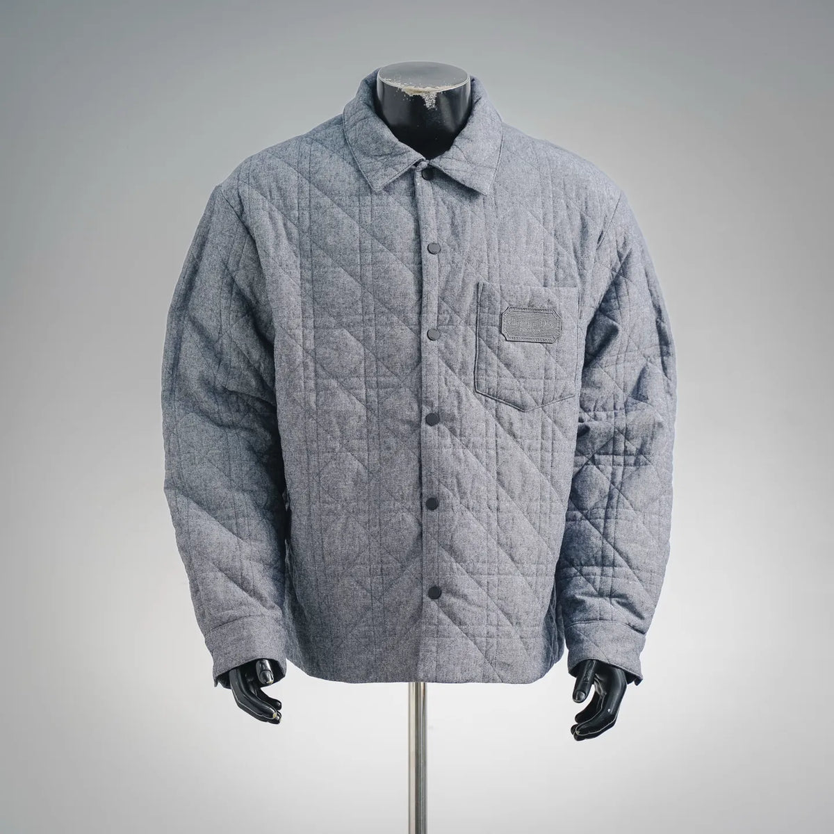 Blue quilted Dior coat with button front and chest pocket