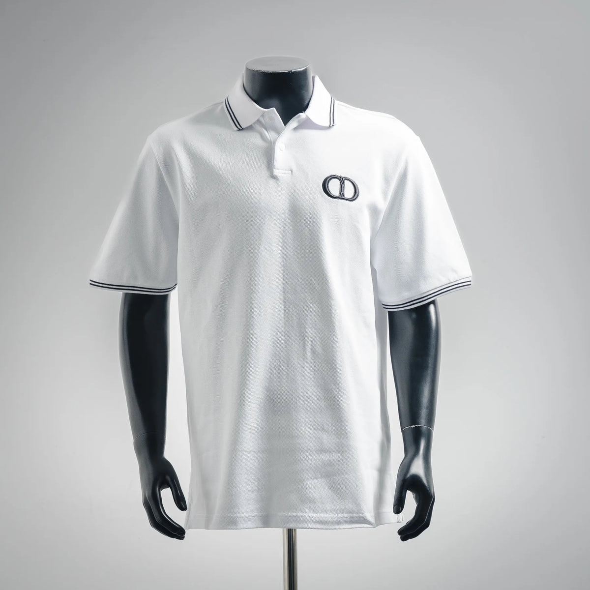 Dior short-sleeve polo shirt in white with navy striped collar and embroidered logo at chest