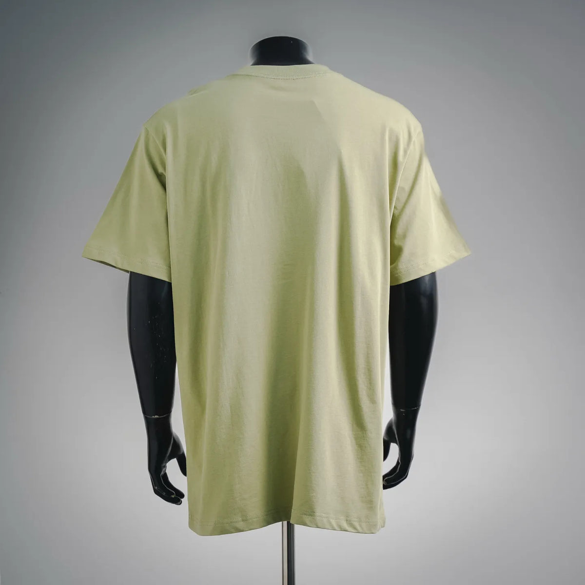 Lime green short-sleeve T-shirt on mannequin, plain back with curved hem
