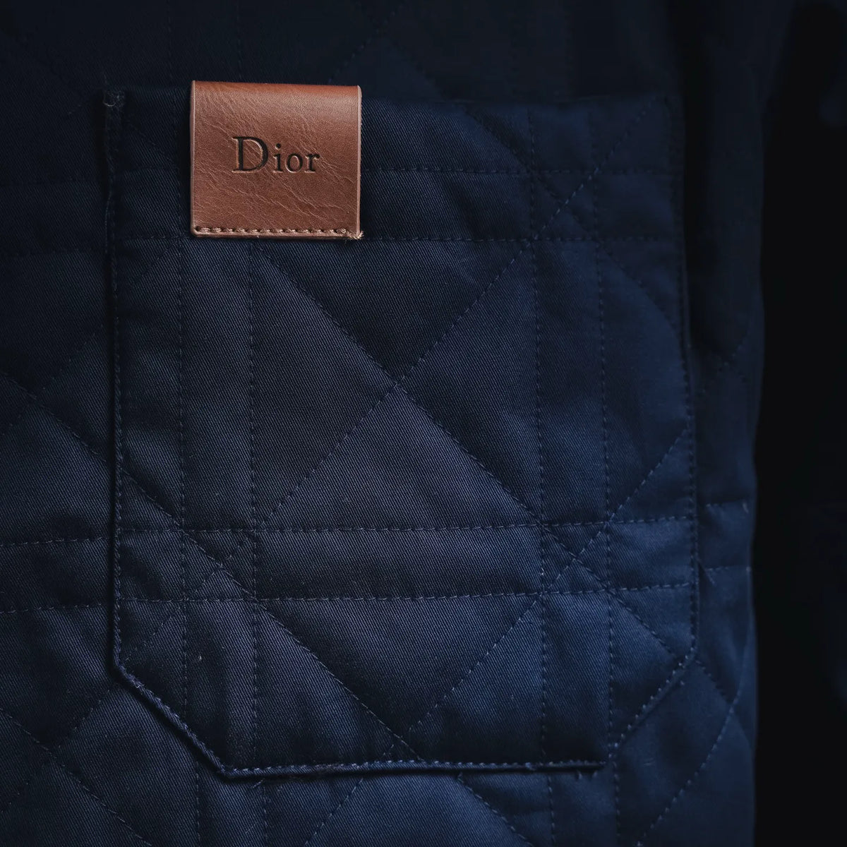 Blue quilted coat with Dior leather label on the chest pocket