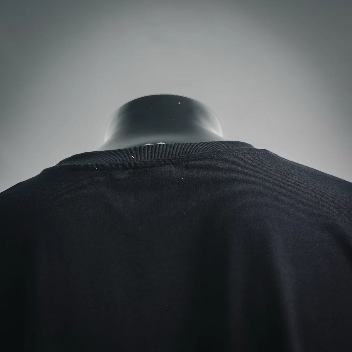 Black T-shirt back neckline and shoulder seam close-up