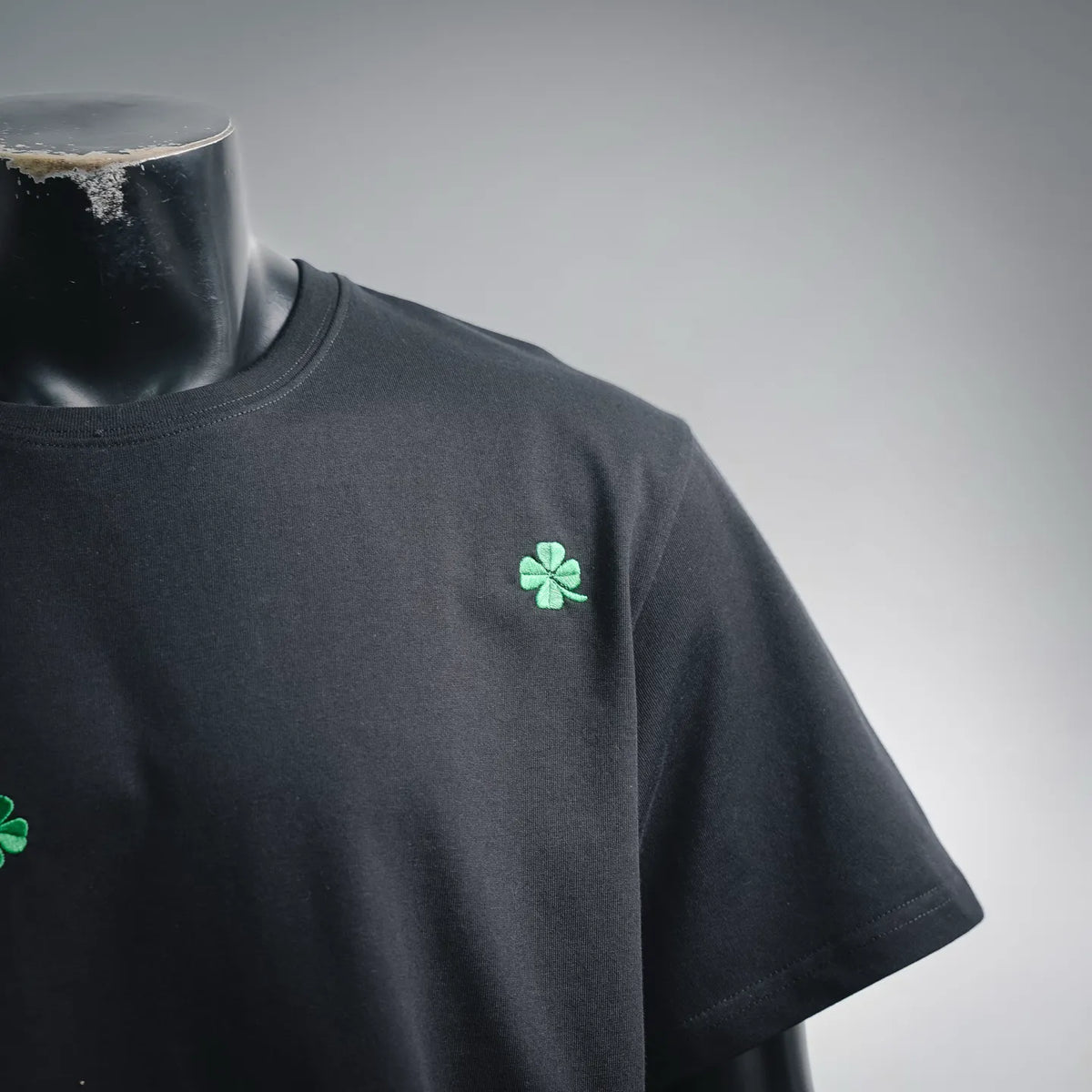 Black Dior T-shirt with green clover logo on chest