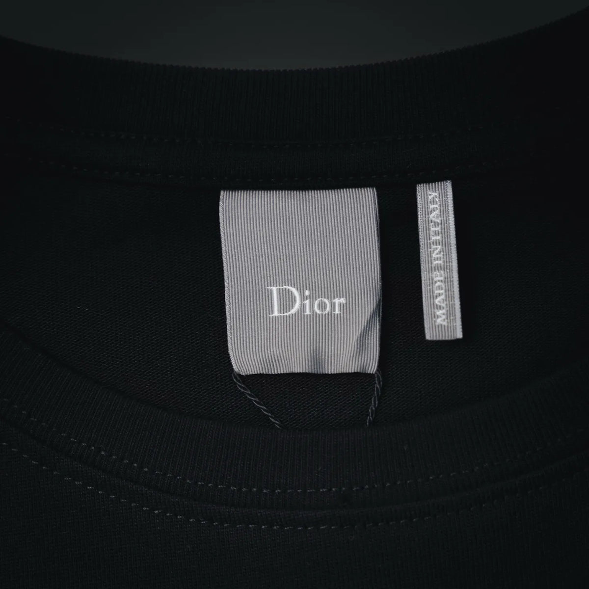 Black Dior T-shirt neckline with Dior size and brand tag