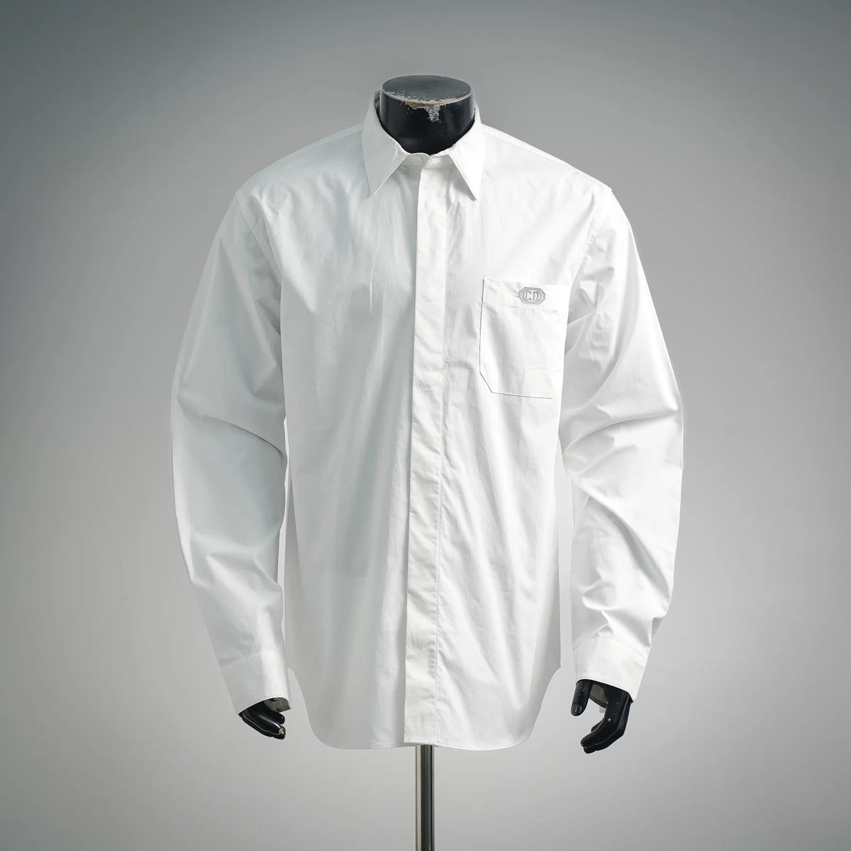White long-sleeve button-up shirt with chest pocket and Dior logo at front