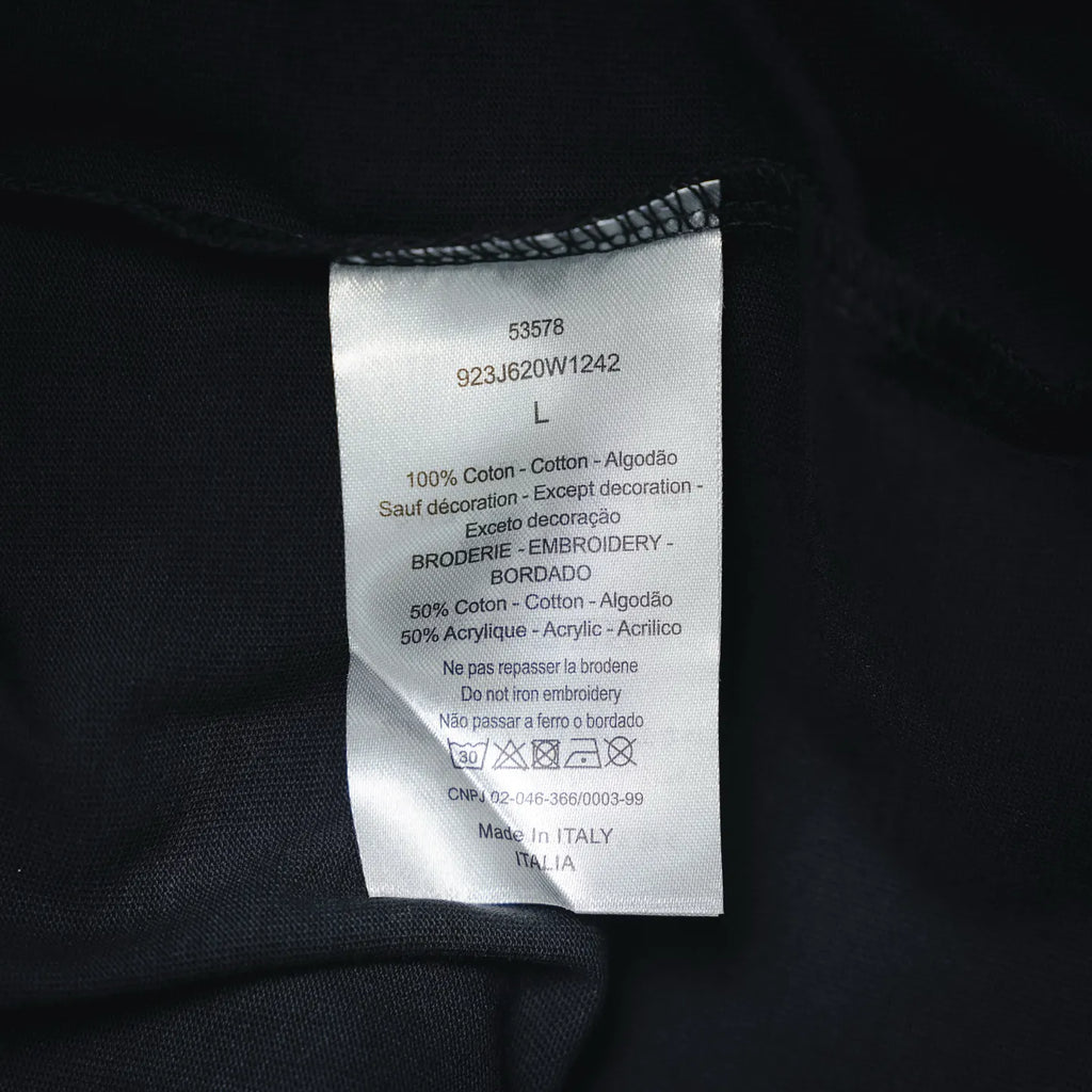 Clothing care and size label on dark Dior short-sleeve T-shirt
