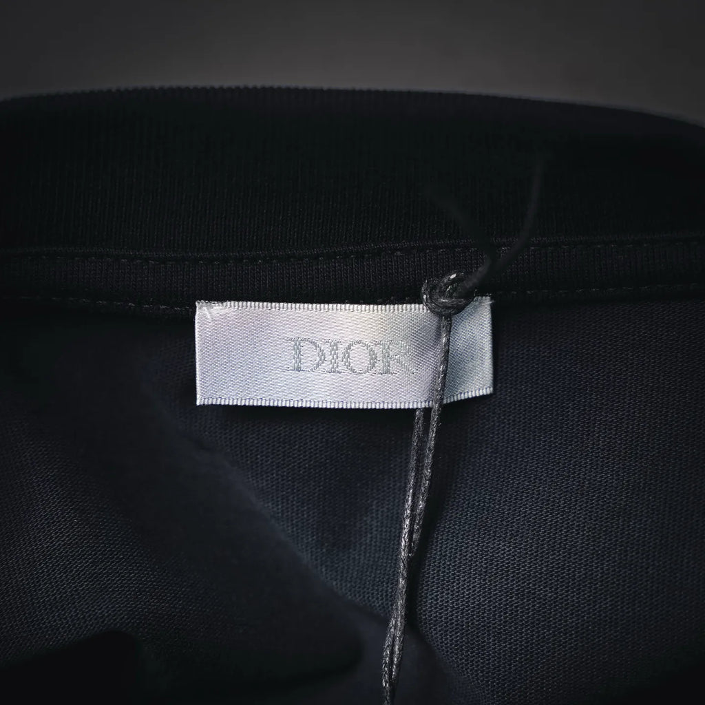 Dior fabric label at neckline on dark short-sleeve T-shirt
