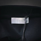 Dior fabric label at neckline on dark short-sleeve T-shirt