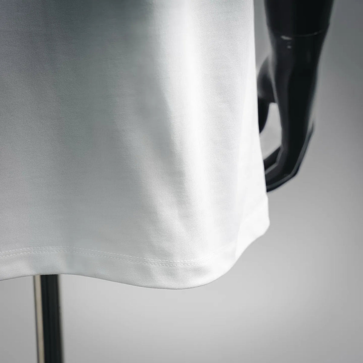 White T-shirt hem with stitched edge, close-up