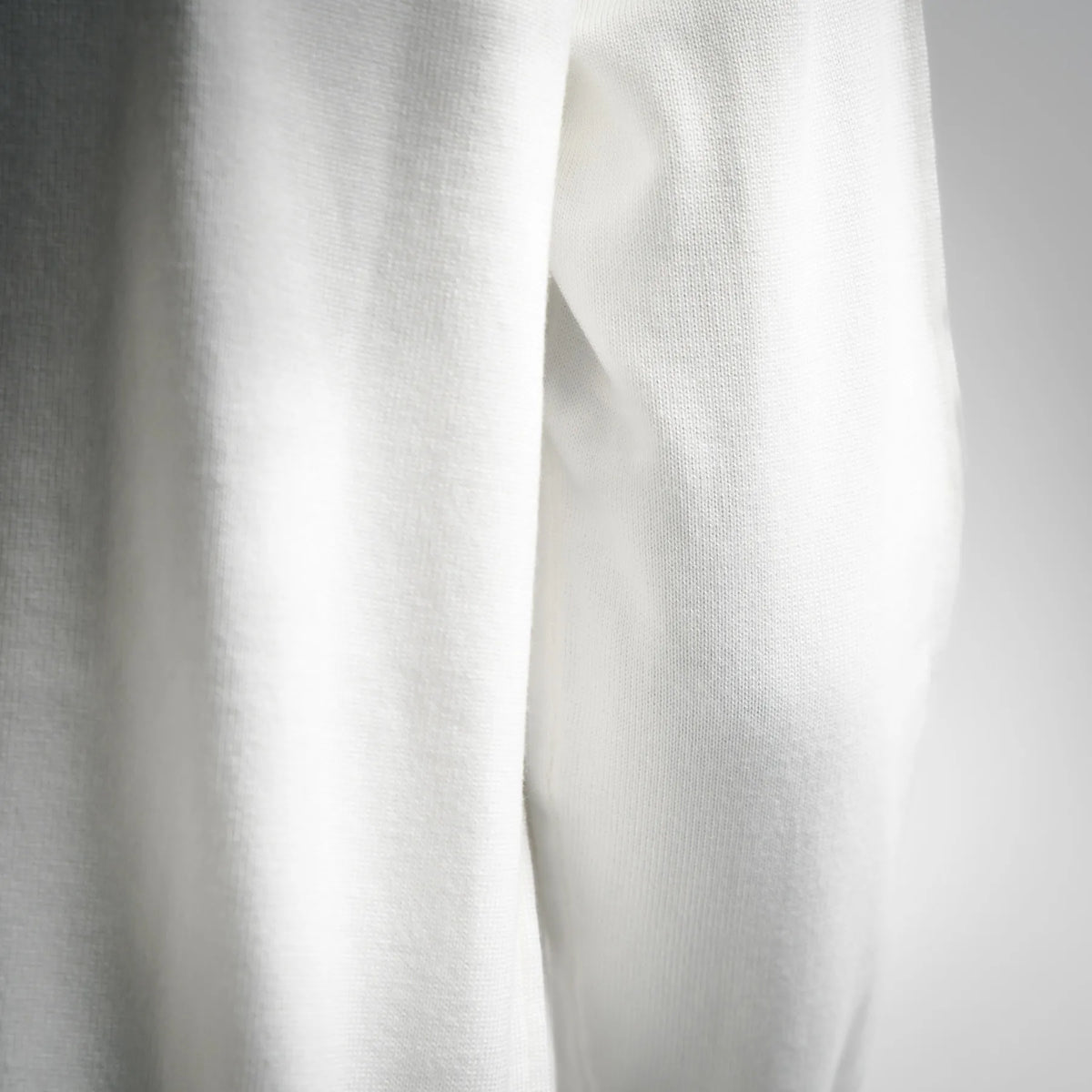 White knit sweater fabric texture close-up