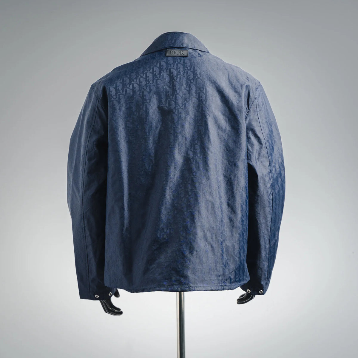 Dior logo-pattern coat in dark blue, back view with pointed collar