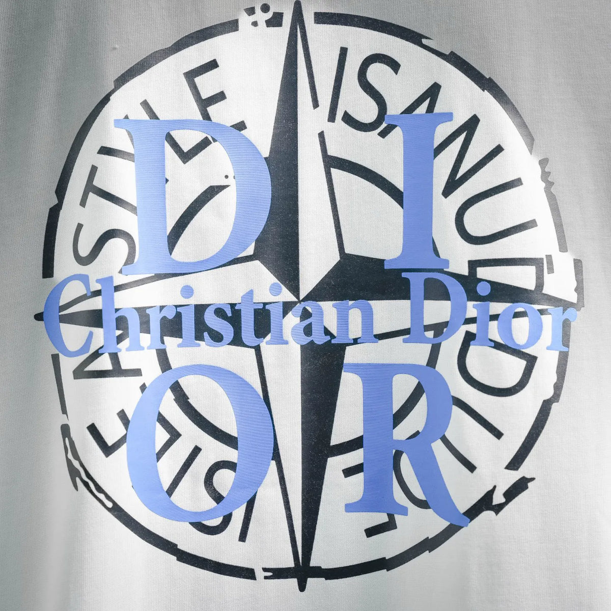 White Dior T-shirt with circular blue “Dior” and “OR” logo text graphic