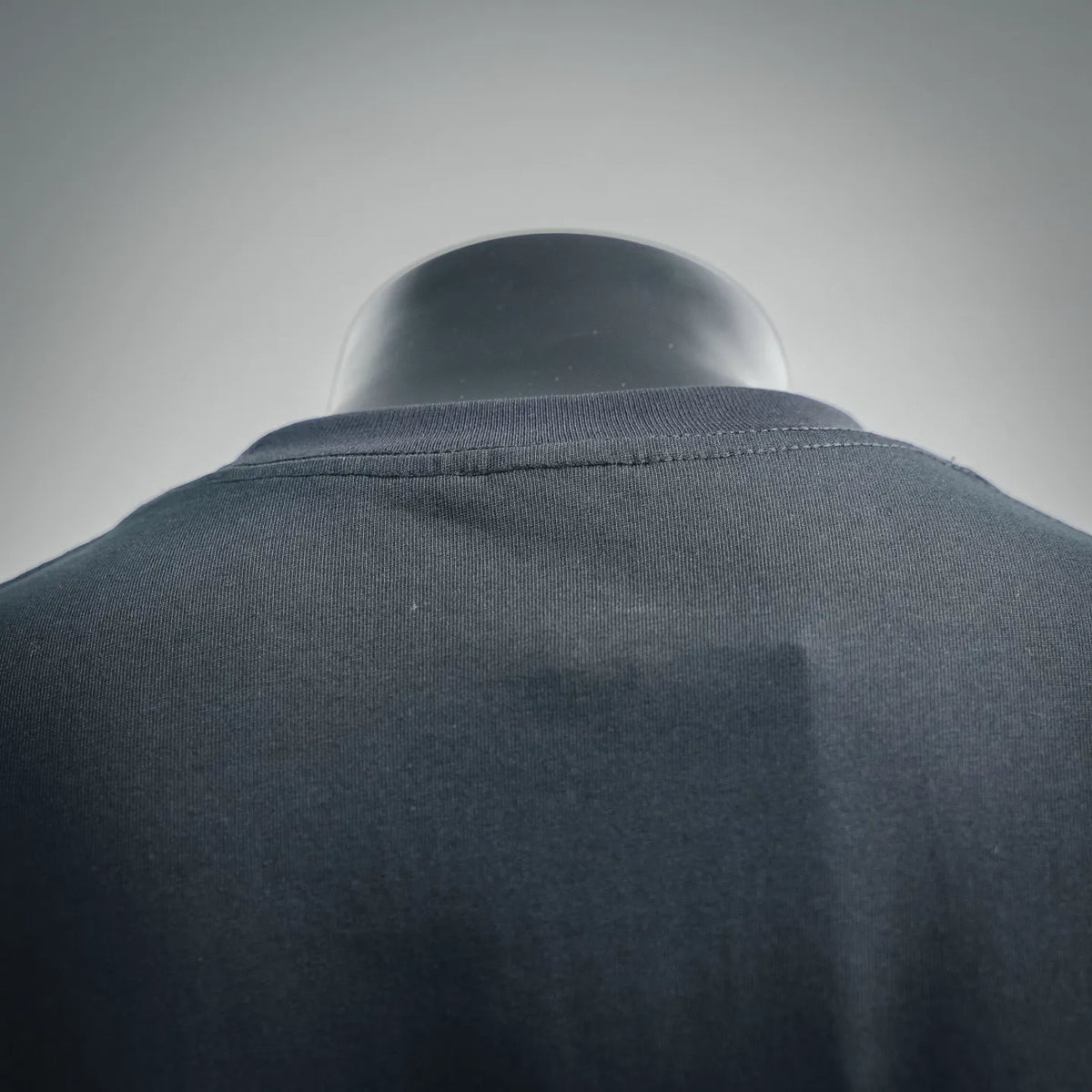 Dark T-shirt back neckline close-up with ribbed crew collar