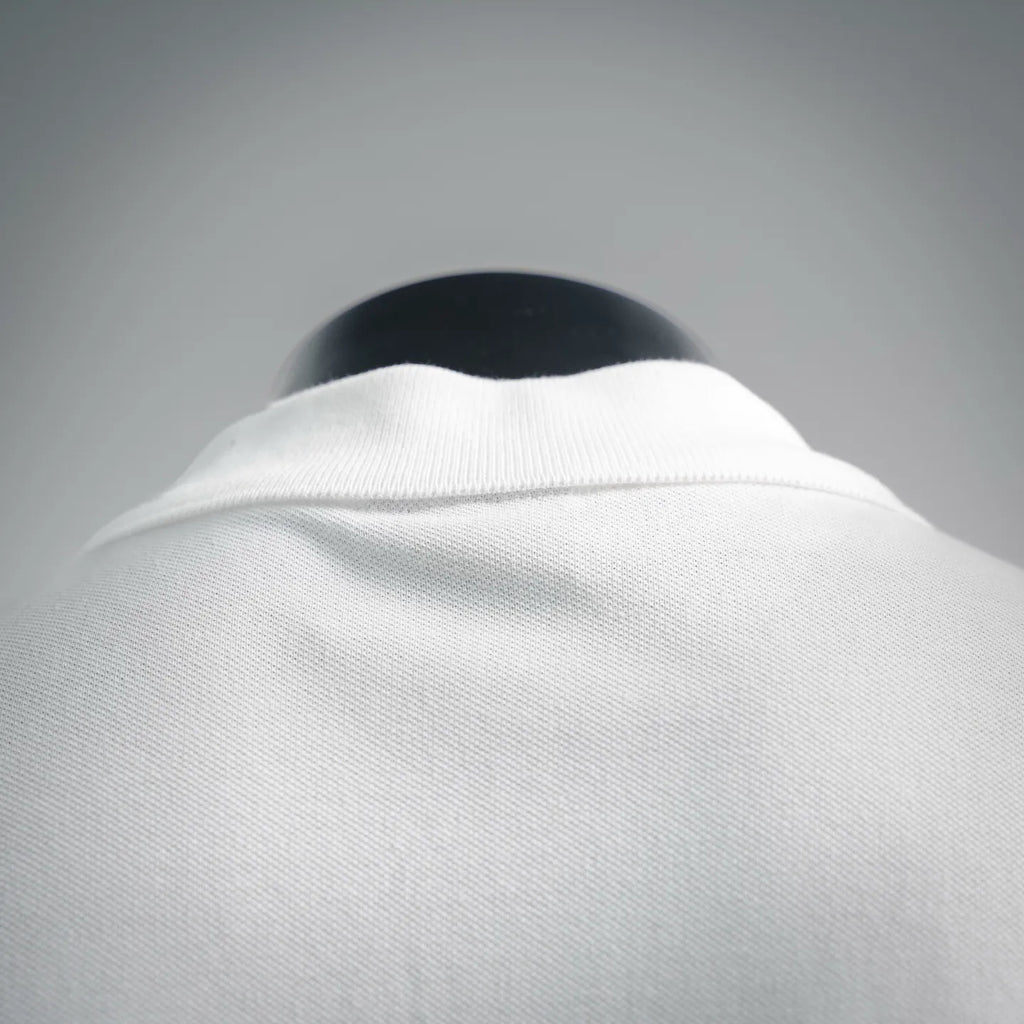 White polo shirt collar close-up with ribbed neckline detail.