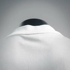 White polo shirt collar close-up with ribbed neckline detail.
