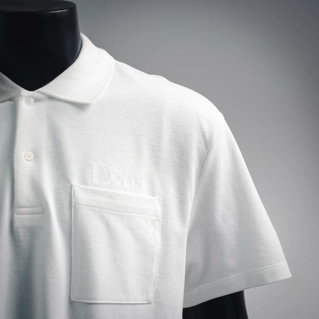 White Dior polo shirt chest pocket with embroidered Dior logo.