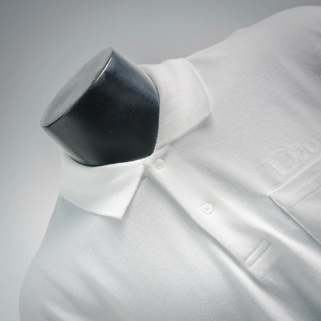 White polo shirt button placket close-up with small front buttons.