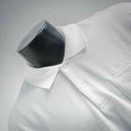 White polo shirt button placket close-up with small front buttons.