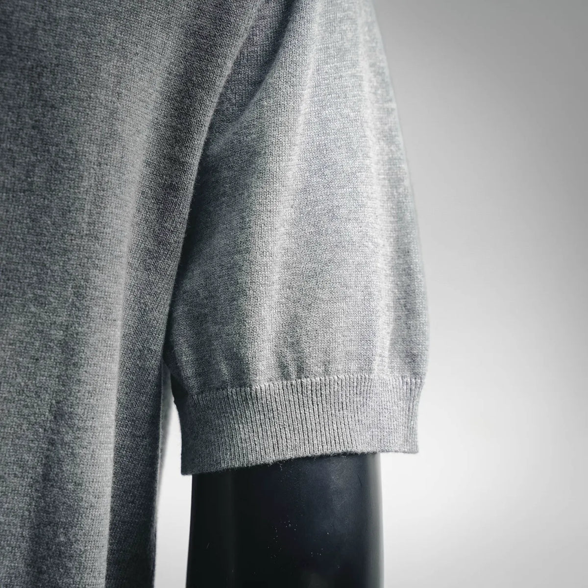 Dior knit polo shirt sleeve and side hem detail, light heather gray knit