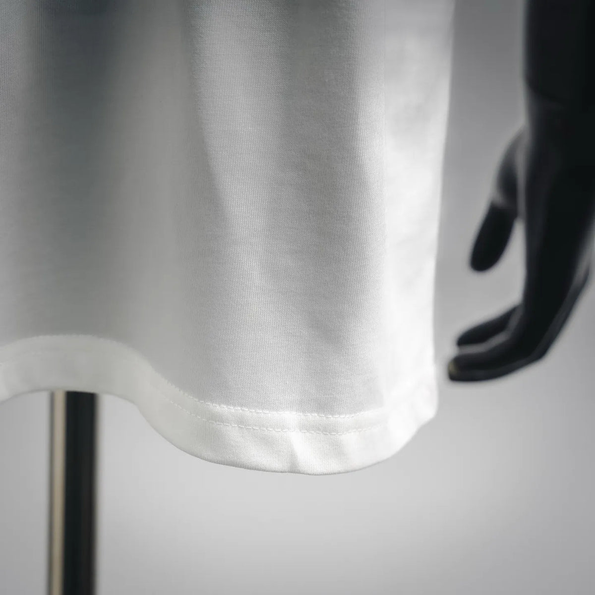 White T-shirt hem with stitched edge detail