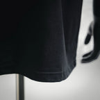 Dior crewneck T-shirt hem detail in dark fabric with stitched edge
