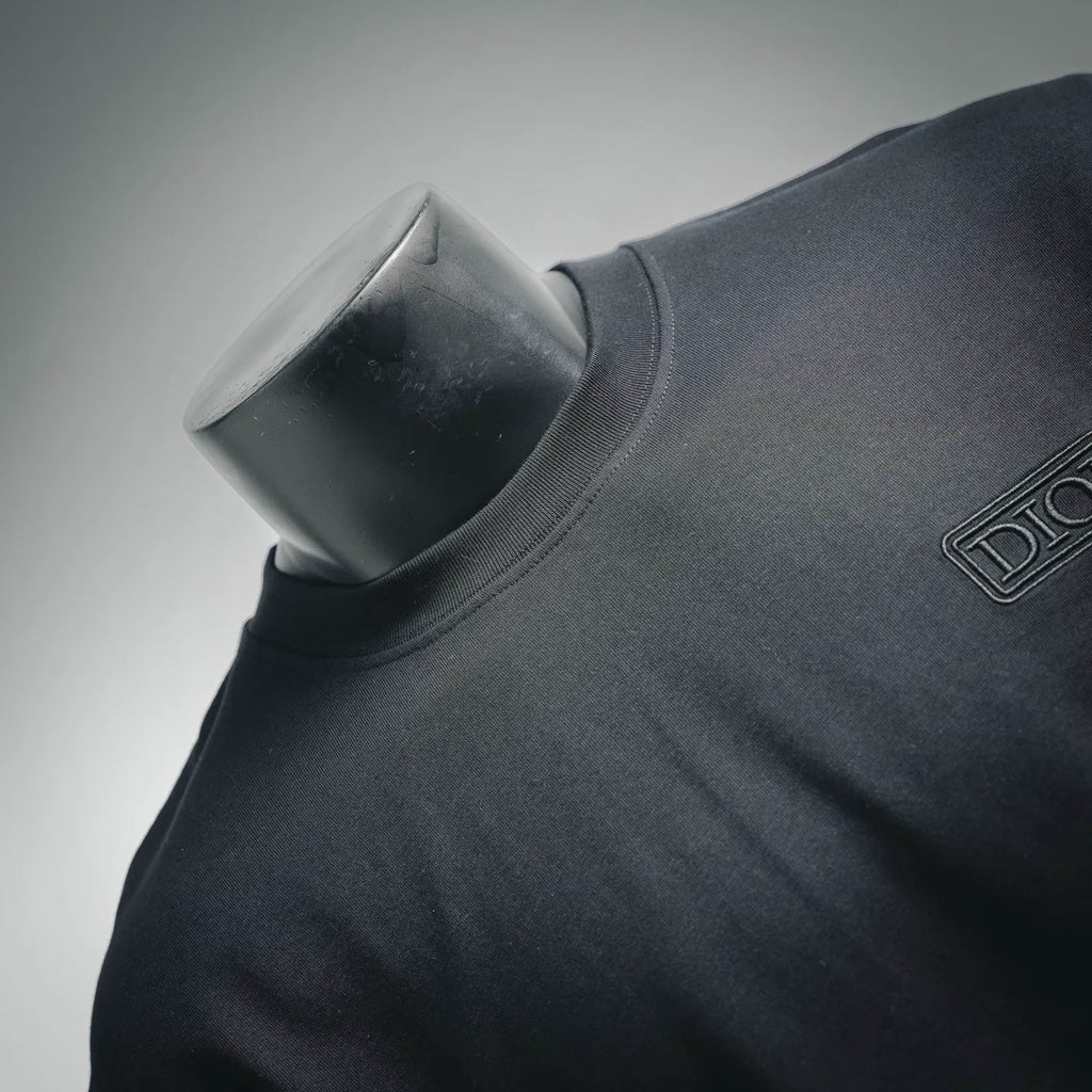 Dior crewneck collar and shoulder close-up on dark short-sleeve T-shirt