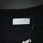 Dior neck label inside dark T-shirt with stitched neckline seam