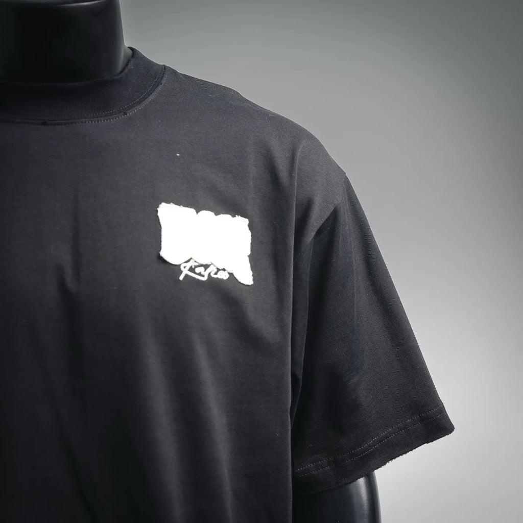 Black short-sleeve T-shirt front view with small white Dior logo patch on chest