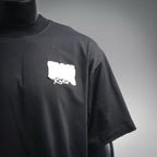 Black short-sleeve T-shirt front view with small white Dior logo patch on chest