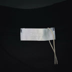 Inside neck tag with “Dior” label on black short-sleeve T-shirt