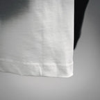 White Dior T-shirt hem close-up with visible stitching and clean seam finish