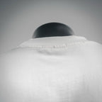 White Dior T-shirt collar close-up with ribbed neckline and top seam