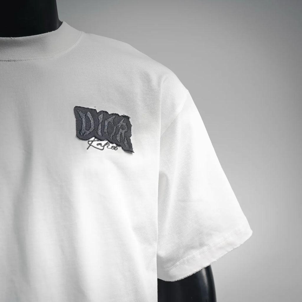 White Dior T-shirt side view with black chest logo patch and short sleeve