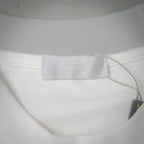 White Dior T-shirt inner neck label with Dior branding and attached fabric tag