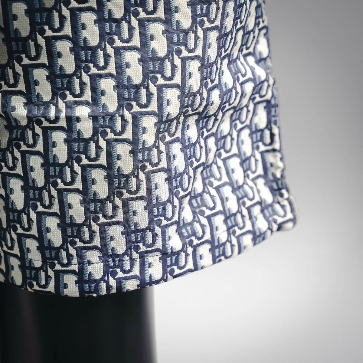Blue and white Dior logo pattern shorts fabric close-up