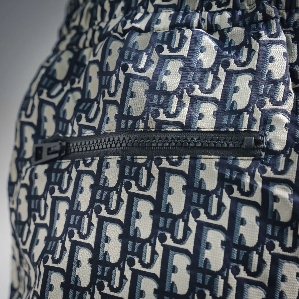 Blue and white Dior logo shorts with woven trim and textured waistband