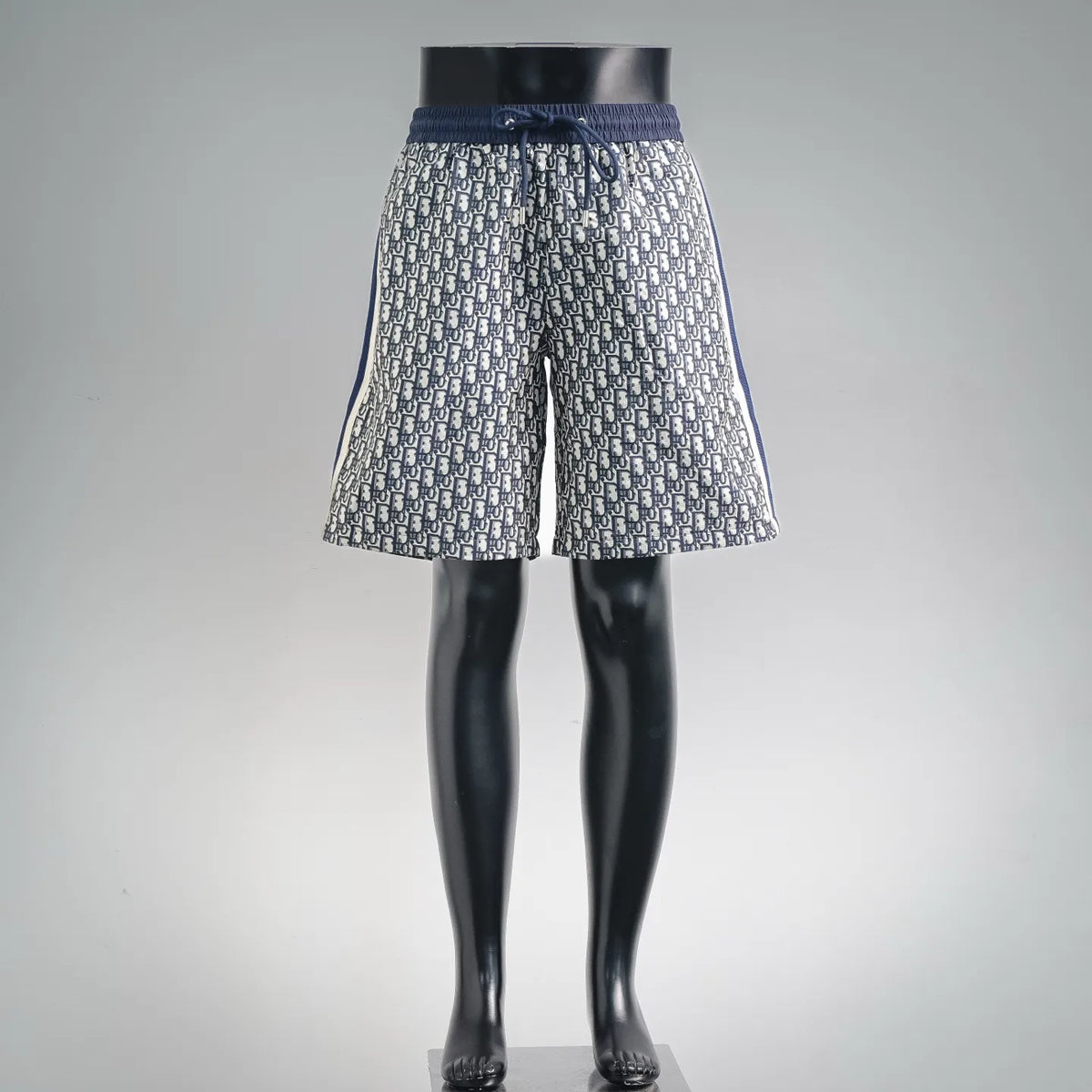 Dior shorts with navy and cream monogram pattern, elastic waistband